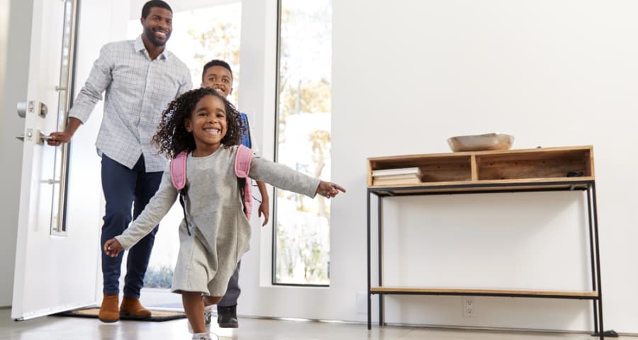 Father and kids entering through the front door